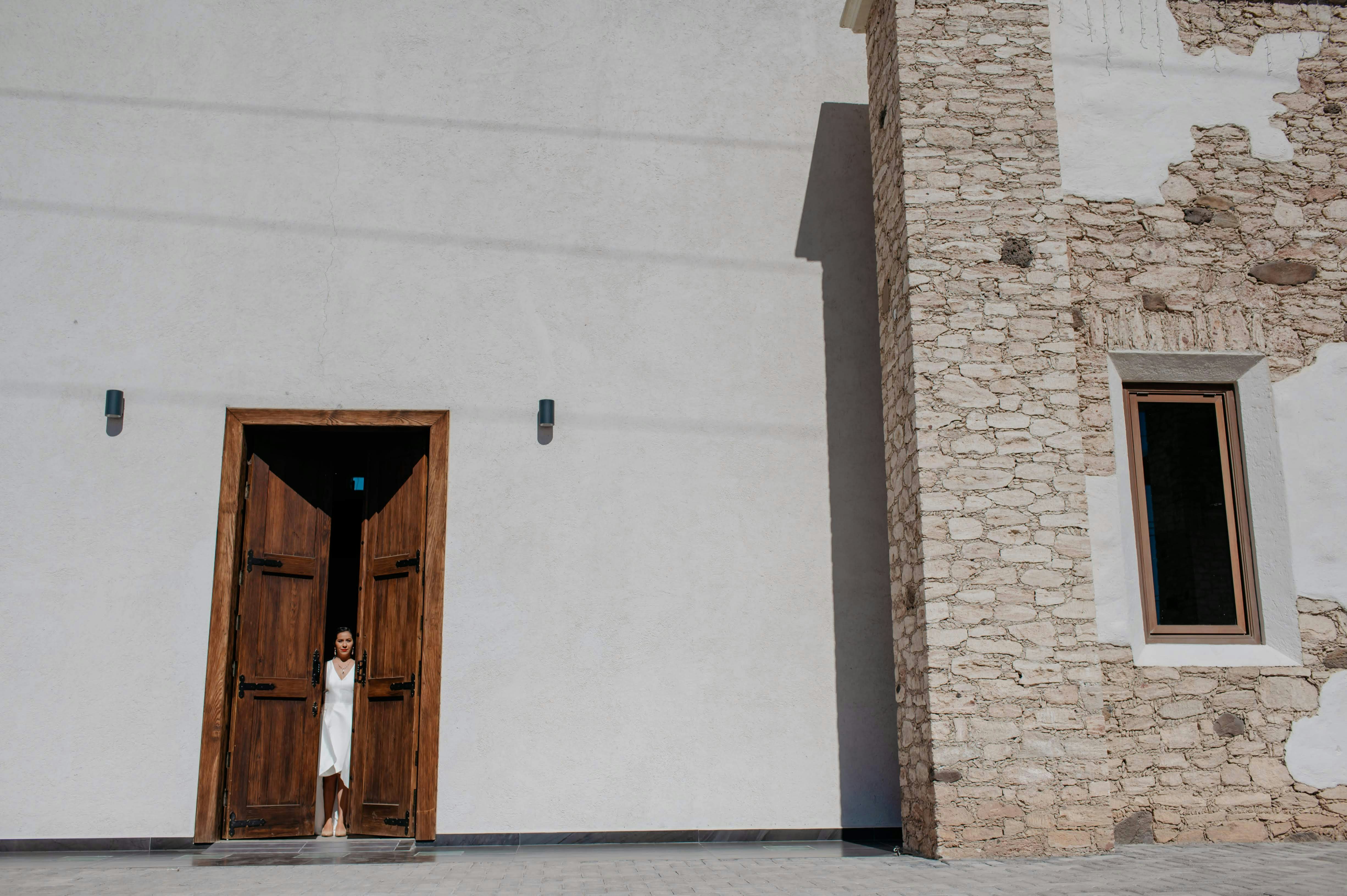 brown wooden door on white concrete building